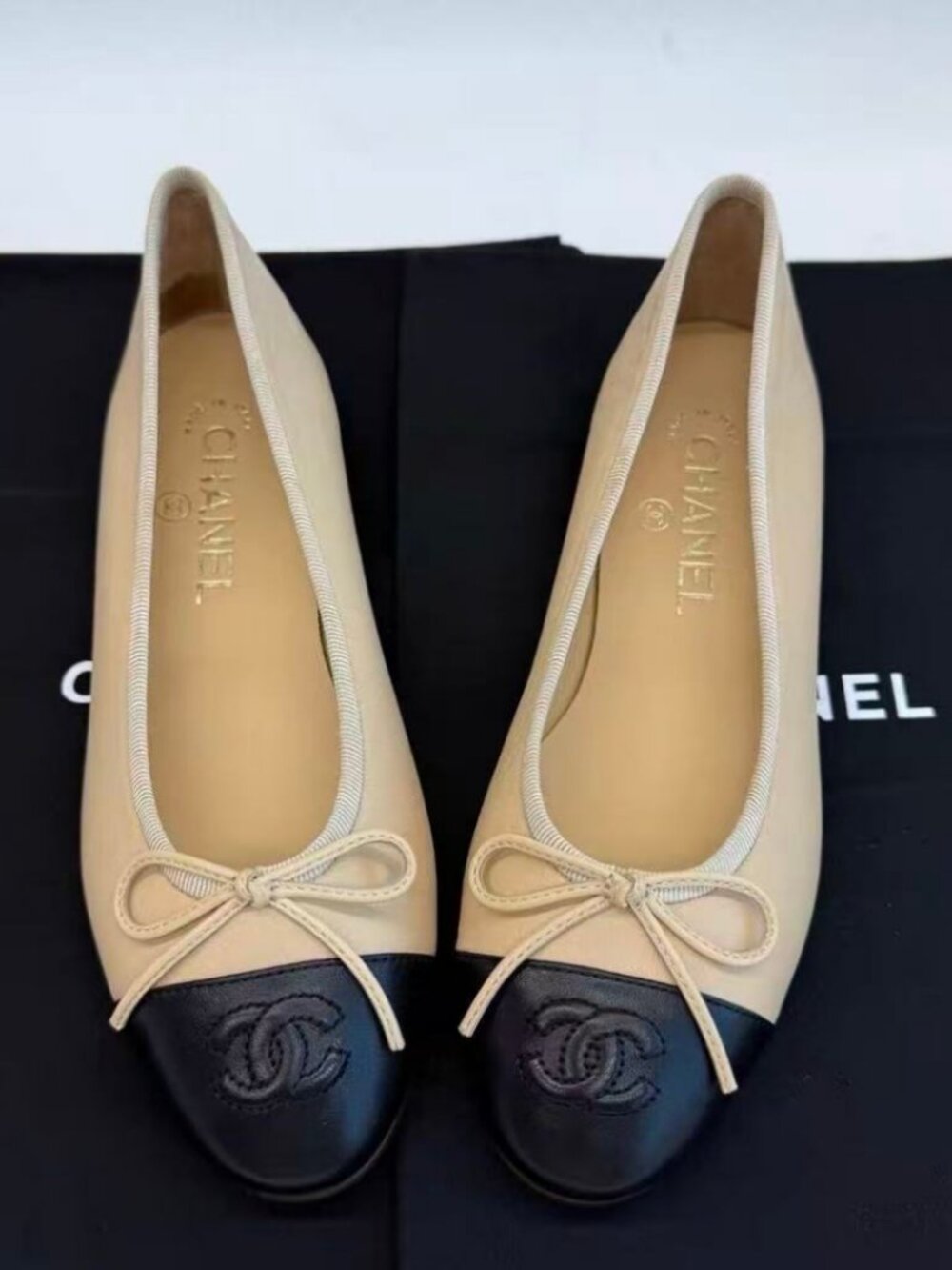 CHANEL Classic Round Toe Two‑Tone Bow Logo Ballet Flats